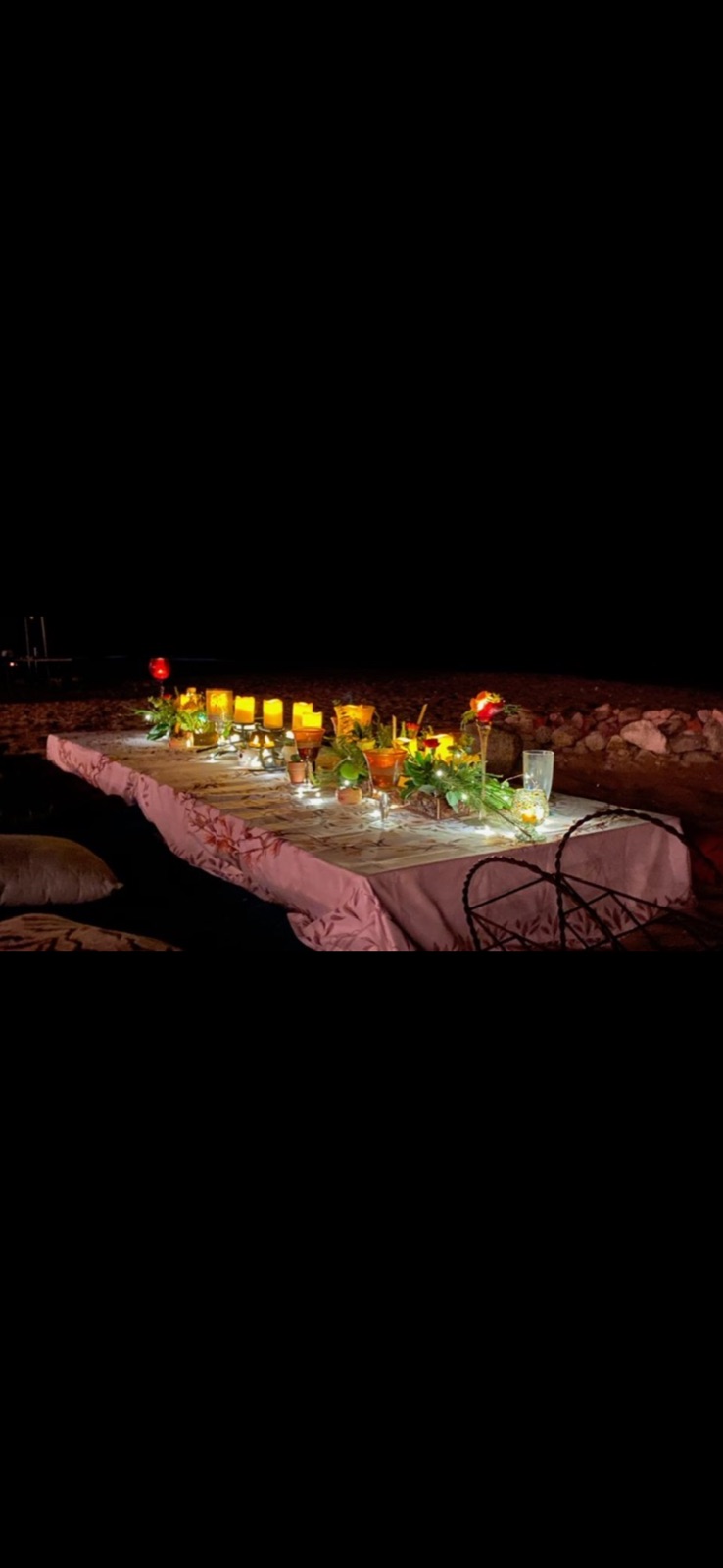 Shabbat table inspiration with candles and flowers under the night sky
